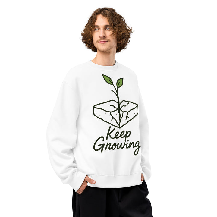 Person wearing a white sweatshirt with 'Keep Growing' design on a white background